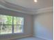 Bright bedroom featuring a large window showcasing beautiful outdoor views and natural light at 8344 Sw 57Th Ct, Ocala, FL 34476