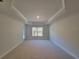 Spacious bedroom with tray ceiling and large window, providing ample natural light at 8344 Sw 57Th Ct, Ocala, FL 34476