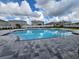 Community pool and deck area with neighborhood homes in the background at 8344 Sw 57Th Ct, Ocala, FL 34476