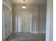 Light-filled entryway with tile flooring, white doors, and transom window above the front door at 8344 Sw 57Th Ct, Ocala, FL 34476