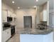 Spacious kitchen with granite countertops, white cabinets, and modern stainless steel appliances at 8344 Sw 57Th Ct, Ocala, FL 34476