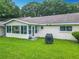 A well-maintained backyard featuring a covered grill area and a screened-in porch at 8351 Sw 93Rd Ln # D, Ocala, FL 34481