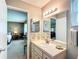 Neutral bathroom with a single sink, mirrored vanity and a bedroom view at 8351 Sw 93Rd Ln # D, Ocala, FL 34481