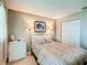 Serene bedroom featuring a queen bed, built-in sconces, and a spacious closet at 8351 Sw 93Rd Ln # D, Ocala, FL 34481
