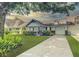 Charming single-story home with manicured lawn, mature trees, and an attached garage at 8351 Sw 93Rd Ln # D, Ocala, FL 34481