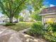 Well-maintained front yard with mature trees, lush landscaping, and a cozy neighborhood feel at 8351 Sw 93Rd Ln # D, Ocala, FL 34481