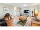 Bright living room featuring hardwood floors, comfortable seating, and stylish decor at 8351 Sw 93Rd Ln # D, Ocala, FL 34481