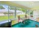 Bright sun room with large windows offering backyard views and comfortable seating at 8351 Sw 93Rd Ln # D, Ocala, FL 34481
