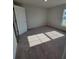 Cozy bedroom showcasing a large window and plush carpeting at 8468 Sw 59Th Ter, Ocala, FL 34476