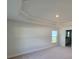 Spacious bedroom featuring neutral walls, plush carpeting, and a tray ceiling at 8468 Sw 59Th Ter, Ocala, FL 34476