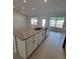 Bright kitchen showcasing a center island, stainless steel appliances, and tile flooring at 8468 Sw 59Th Ter, Ocala, FL 34476