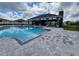 Community pool with a view of the community pavilion and surrounding homes on a sunny day at 8468 Sw 59Th Ter, Ocala, FL 34476