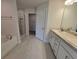 Bright bathroom with double vanity, granite countertops, white cabinets, tub, and a separate shower with glass doors at 8482 Sw 59Th Ter, Ocala, FL 34476