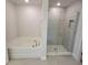 Bathroom with a soaking tub and a glass-enclosed shower, designed for relaxation and functionality at 8482 Sw 59Th Ter, Ocala, FL 34476