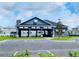 Community building featuring a covered seating area, stone accents, and well-maintained landscaping in a suburban neighborhood at 8482 Sw 59Th Ter, Ocala, FL 34476