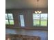 Dining area with chandelier, backyard access and sunlit window at 8482 Sw 59Th Ter, Ocala, FL 34476