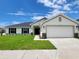 Beautiful single-story home with a well-manicured lawn and a two-car garage at 8482 Sw 59Th Ter, Ocala, FL 34476