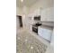 Modern kitchen with white cabinets, granite countertops, and stainless steel appliances at 8483 Sw 59Th Ter, Ocala, FL 34476