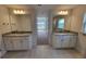Double vanities with granite countertops, and tile flooring at 8483 Sw 59Th Ter, Ocala, FL 34476