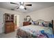 Bedroom featuring natural light, carpet, ceiling fan and an adjacent bathroom at 8990 Se 155Th Pl, Summerfield, FL 34491