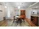 Dining area features a wooden table set, wood floors, chandelier, and natural light at 8990 Se 155Th Pl, Summerfield, FL 34491