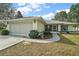 Charming home with a well-maintained lawn, mature shrubbery, and a two-car garage at 8990 Se 155Th Pl, Summerfield, FL 34491