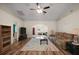 Spacious living room with hardwood floors, neutral paint, ceiling fan and natural light flowing throughout the home at 8990 Se 155Th Pl, Summerfield, FL 34491