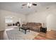 Open-concept living room featuring neutral paint, a vaulted ceiling, hardwood floors, a ceiling fan, and natural light at 8990 Se 155Th Pl, Summerfield, FL 34491