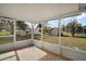 Screened in patio with views of the backyard and additional structures on the property at 8990 Se 155Th Pl, Summerfield, FL 34491