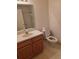 Bathroom featuring toilet, sink with vanity, and shower, providing essential amenities at 9012 Sw 91St Cir, Ocala, FL 34481