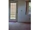 Patio door leading to the backyard, offering natural light and access to outdoor living space at 9012 Sw 91St Cir, Ocala, FL 34481