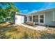Home's exterior back with a gardening box and white door at 9058 Sw 108Th Pl, Ocala, FL 34481