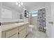 Clean bathroom featuring a vanity, sink, and shower with patterned shower curtain at 9058 Sw 108Th Pl, Ocala, FL 34481