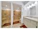 Updated bathroom features a glass enclosed shower, tiled walls, and an updated vanity at 9058 Sw 108Th Pl, Ocala, FL 34481
