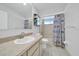 Well-lit bathroom with a single sink, vanity, and a shower-tub combination featuring a shower curtain at 9058 Sw 108Th Pl, Ocala, FL 34481
