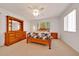 Cozy bedroom featuring a comfortable bed, matching dresser, and bright natural light at 9058 Sw 108Th Pl, Ocala, FL 34481