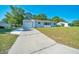 Lovely one-story home with a garage and driveway, complemented by a green lawn and serene surroundings at 9058 Sw 108Th Pl, Ocala, FL 34481