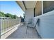 Cozy tiled porch with seating, shaded by the home's overhang and decorative fence at 9058 Sw 108Th Pl, Ocala, FL 34481