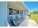 Relaxing front porch area with tile flooring and comfortable seating at 9058 Sw 108Th Pl, Ocala, FL 34481