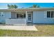 Close-up of the home's entrance with a white decorative fence and glass storm door at 9058 Sw 108Th Pl, Ocala, FL 34481