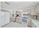 Spacious open kitchen with white cabinets, countertops, and tile flooring at 9058 Sw 108Th Pl, Ocala, FL 34481