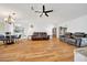 Bright, spacious living room with an open floor plan, hardwood floors, ceiling fan, and comfortable seating at 9058 Sw 108Th Pl, Ocala, FL 34481