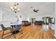 Open-concept living area with hardwood floors, a ceiling fan, and lots of light at 9058 Sw 108Th Pl, Ocala, FL 34481