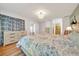 Bright main bedroom with wood floors, neutral walls, an ensuite bathroom, and a dresser at 9058 Sw 108Th Pl, Ocala, FL 34481