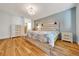 Comfortable main bedroom with wood floors, en-suite bath, and a relaxing decor at 9058 Sw 108Th Pl, Ocala, FL 34481