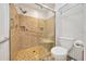 Updated tiled shower with bench, grab bar, and shower head in the main bathroom at 9058 Sw 108Th Pl, Ocala, FL 34481