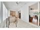 Bright sun room featuring tile floors, a ceiling fan, and views into the home at 9058 Sw 108Th Pl, Ocala, FL 34481