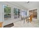 Inviting sunroom with tile floor, and many windows allowing natural light to create a relaxing and peaceful space at 9058 Sw 108Th Pl, Ocala, FL 34481