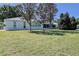 Backyard view of a white house with large windows and manicured lawn at 9088 Sw 95Th Ave, Ocala, FL 34481