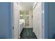 Bathroom hallway view featuring a walk-in shower, large vanity, and tiled floors at 9088 Sw 95Th Ave, Ocala, FL 34481